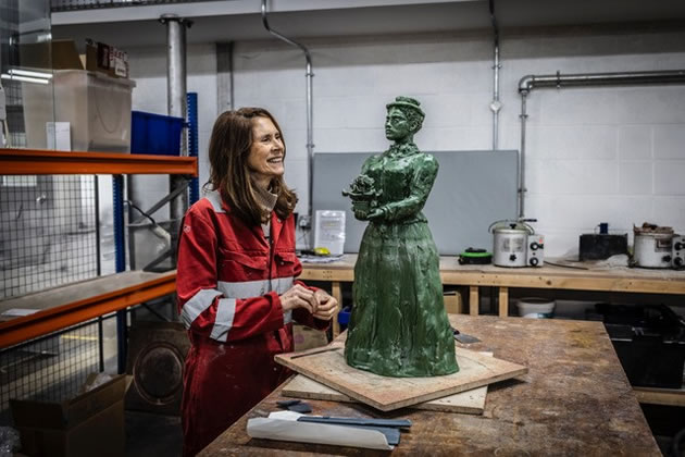 Gillian Brett, the sculptor, working on the statue